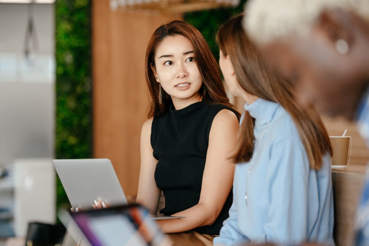 Image of two women at work talking. We can only see one face.